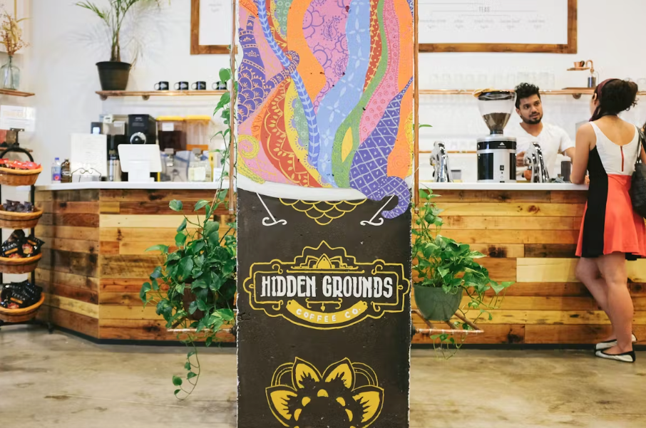 Wooden café counter and colorful mural at Hidden Grounds, 4C Easton Avenue.