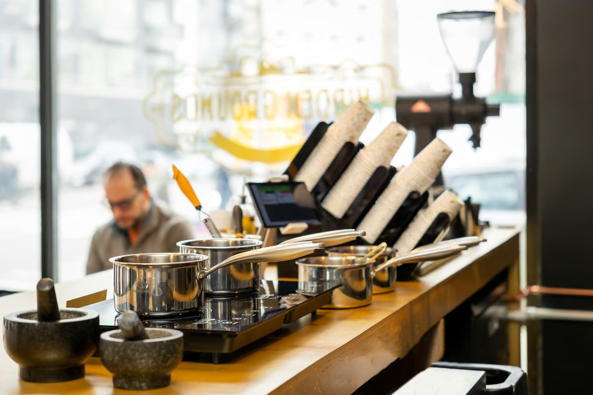 Chai saucepans behind the Hidden Grounds bar